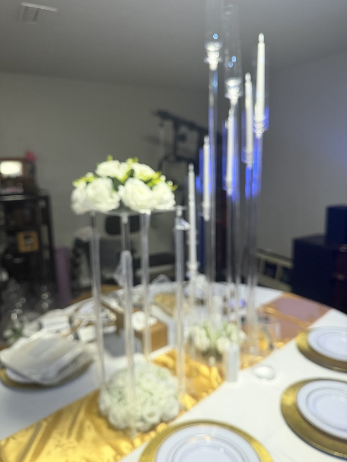 Tall glass candle holders and white flowers in a table centerpiece