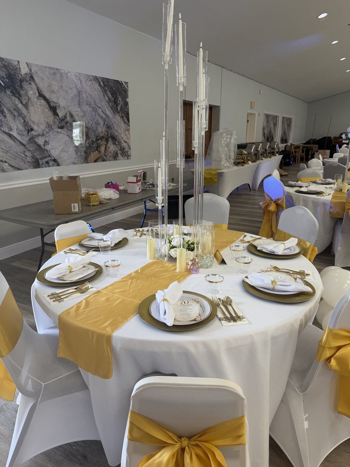Reception table with gold accents and tall candle holders