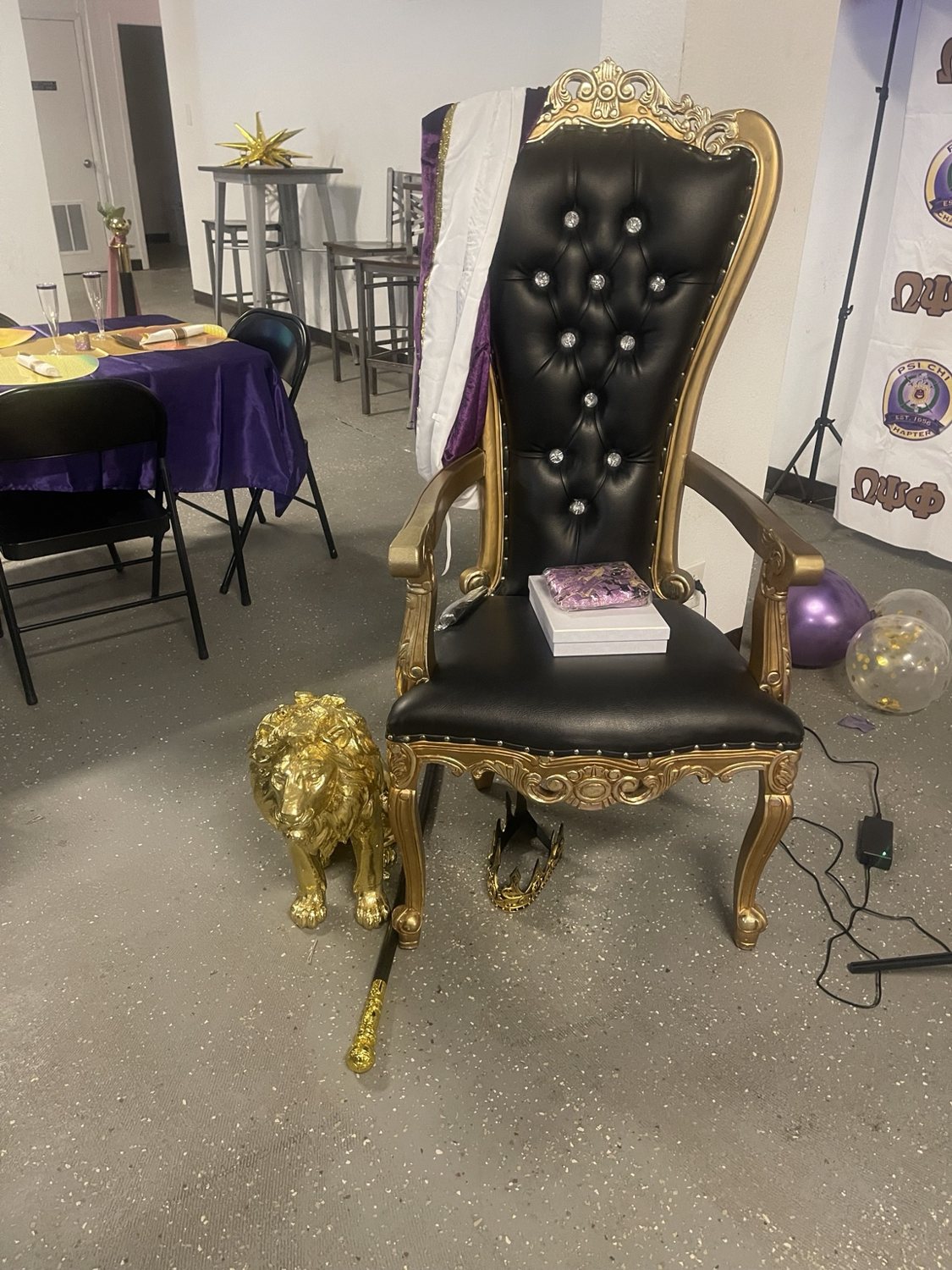 Black and gold ornate chair at a celebration