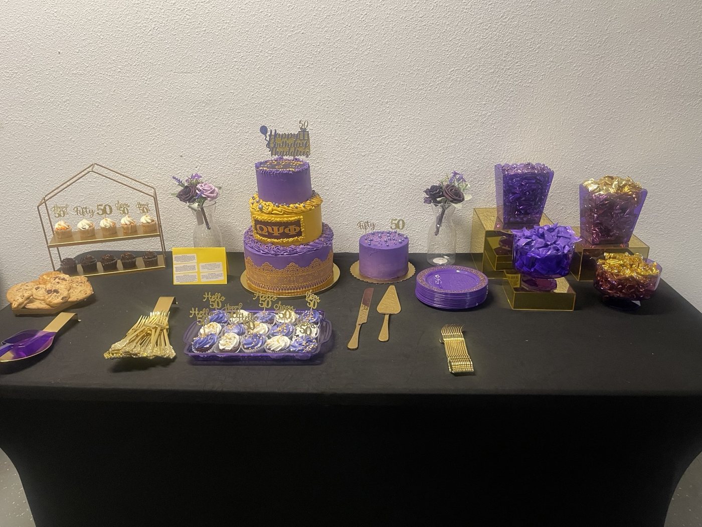 Purple and gold dessert table styled for a milestone birthday