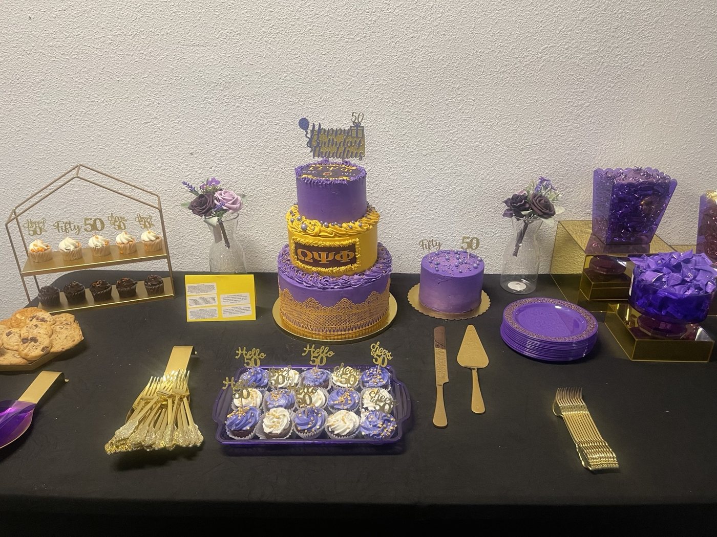 Cake and sweets displayed with purple and gold accents