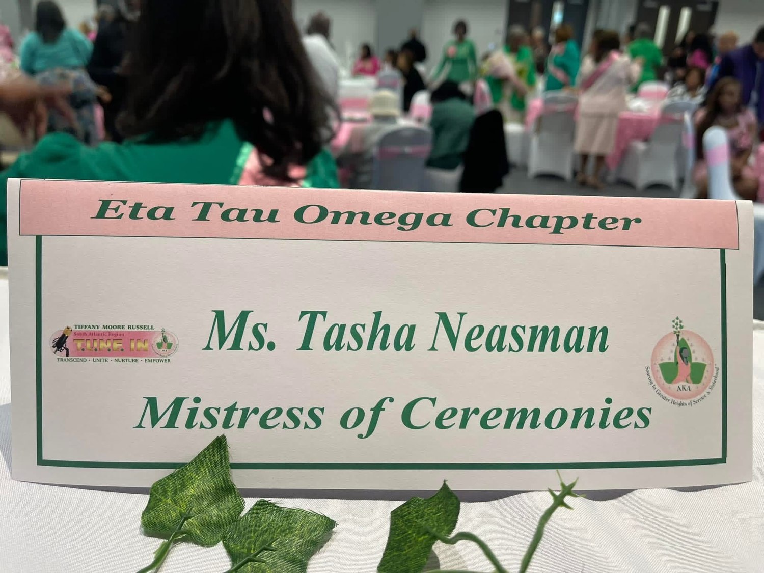 Eta Tau Omega Chapter event placard naming Tasha Neasman as Mistress of Ceremonies